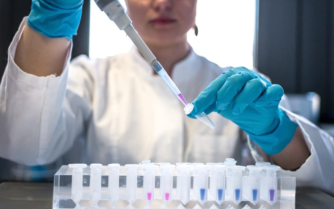 Forensic toxicology scientist preparing a laboratory sample for drug analysis